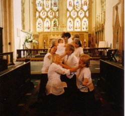 dancers in pairs, cupping each others faces